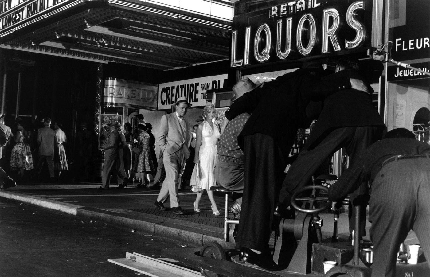 Marilyn Monroe walking with co-star Tom Ewell in front of the Trans-Lux Theater on the corner of 51st Street and Lexington Avenue while filming the famous skirt-blowing scene for “The Seven Year Itch”