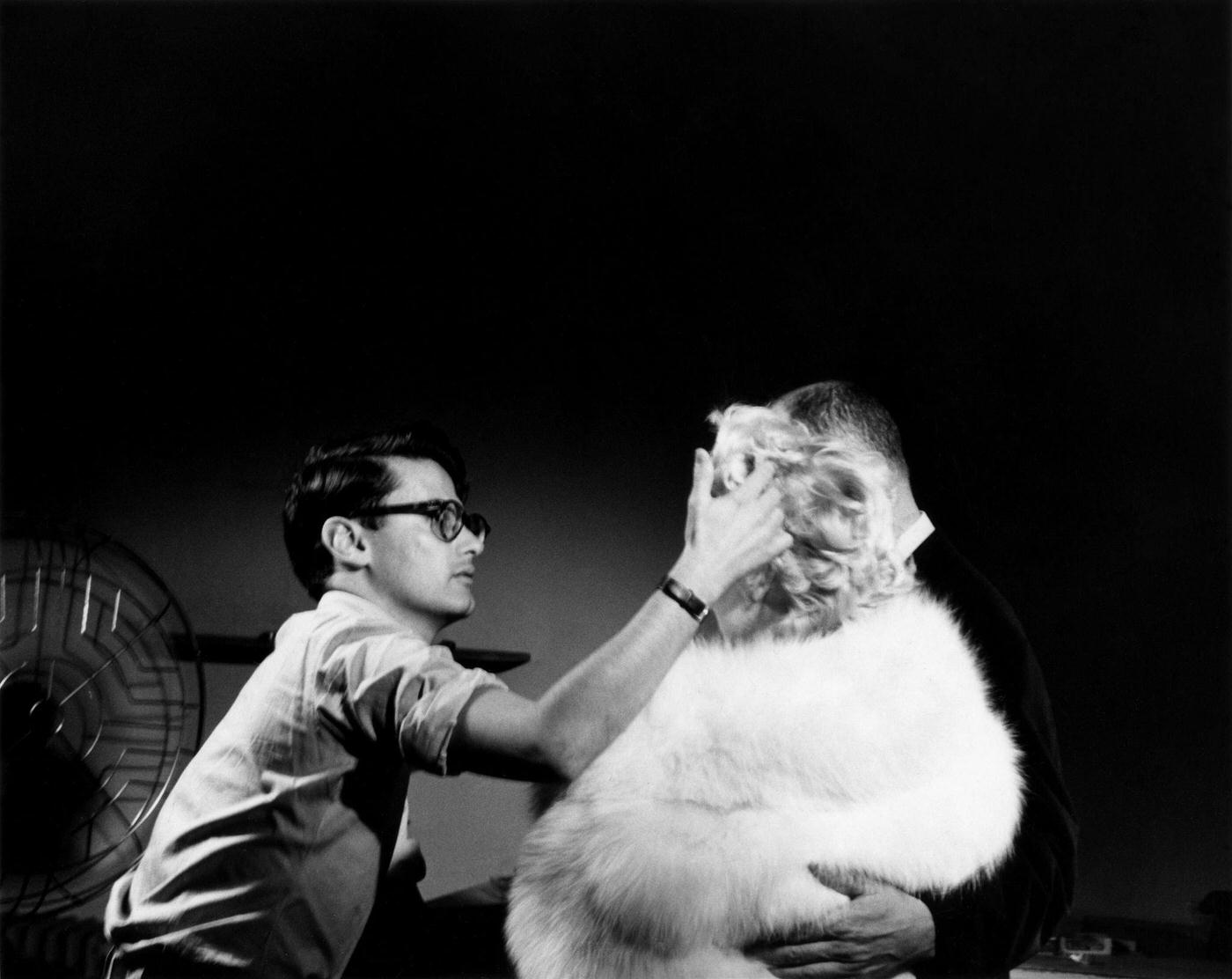 Richard Avedon works on Marilyn Monroe’s hair for a publicity shoot with Director Billy Wilder for “The Seven Year Itch” in 1954 in New York
