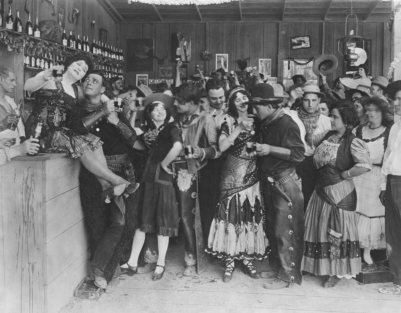 #2 Cowboys and bar girls whoop it up in a still from an old silent Western.