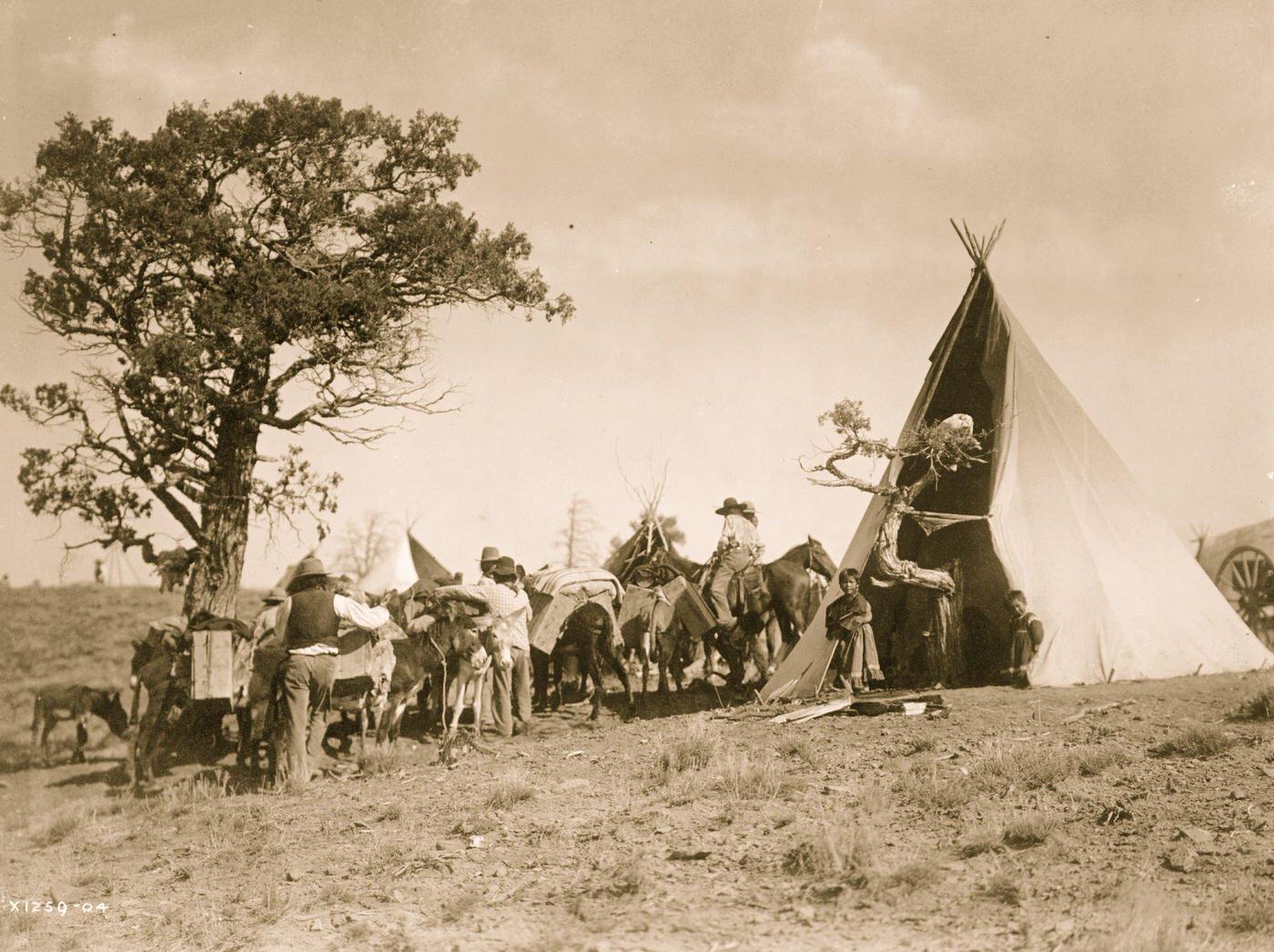 #10 Men and pack animals gathered outside Jicarilla tipi., 1905