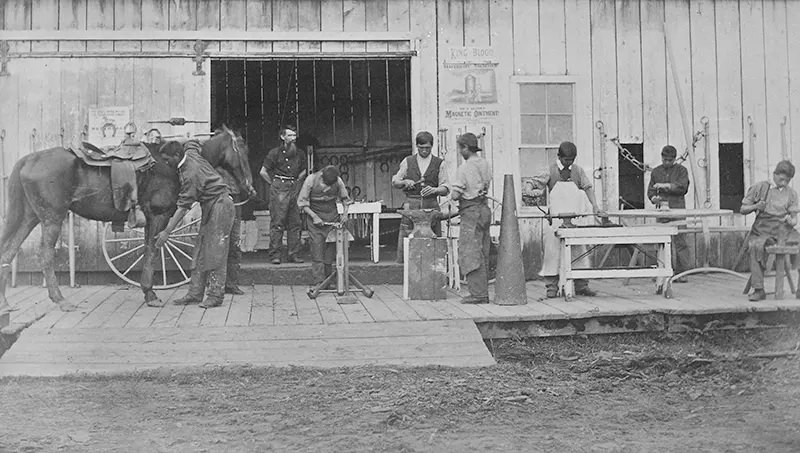#115 This photograph from 1882 shows a class in blacksmithing at the Forest Grove School in Oregon.