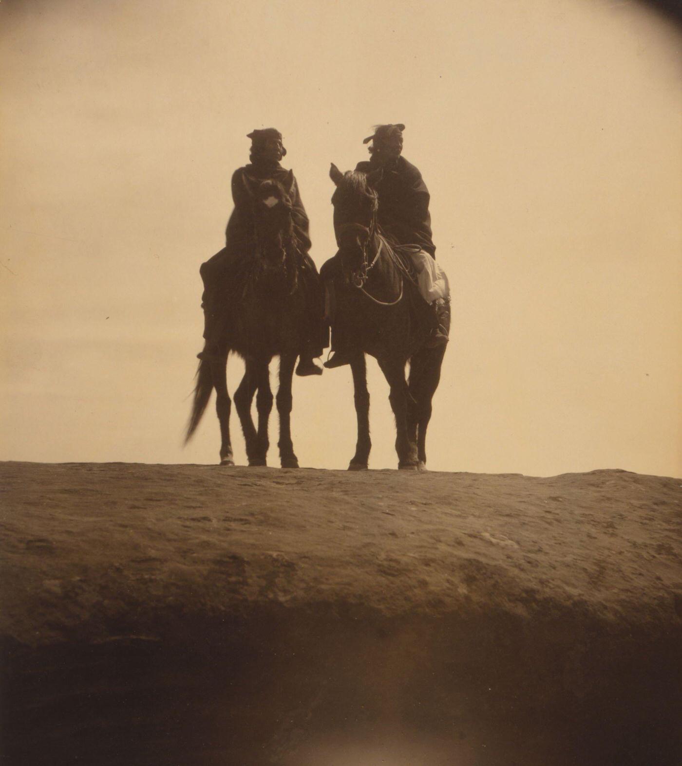 #18 Two native American men mounted on horses, gazing off into the distance, 1904