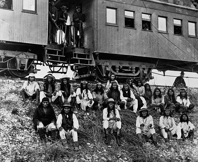 #79 A band of Apache Indian prisoners take a rest stop beside Southern Pacific Railway near Nueces River, Texas in 1886.