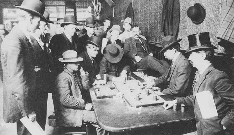#81 Men gather to gamble over a game of Faro inside a saloon in Bisbee, Arizona in 1900.