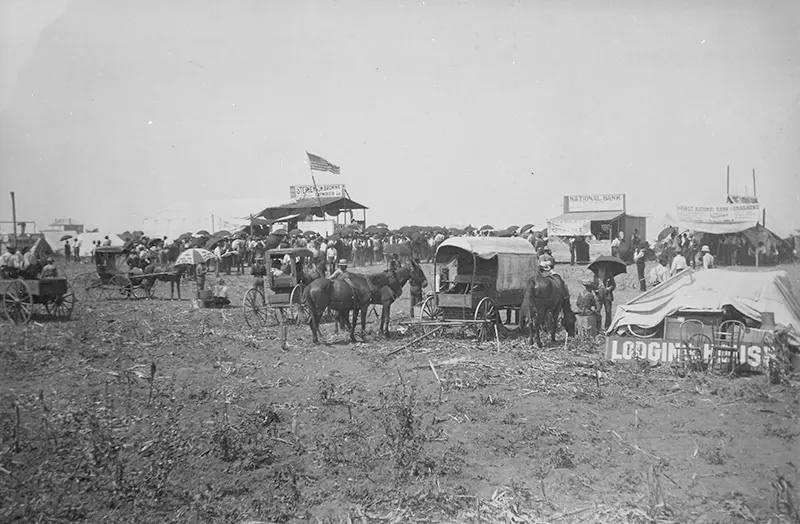 #88 Anadarko Townsite, August 8, 1901: Auction in progress in lumber company booth, with temporary bank buildings and the beginnings of a lodging house nearby.