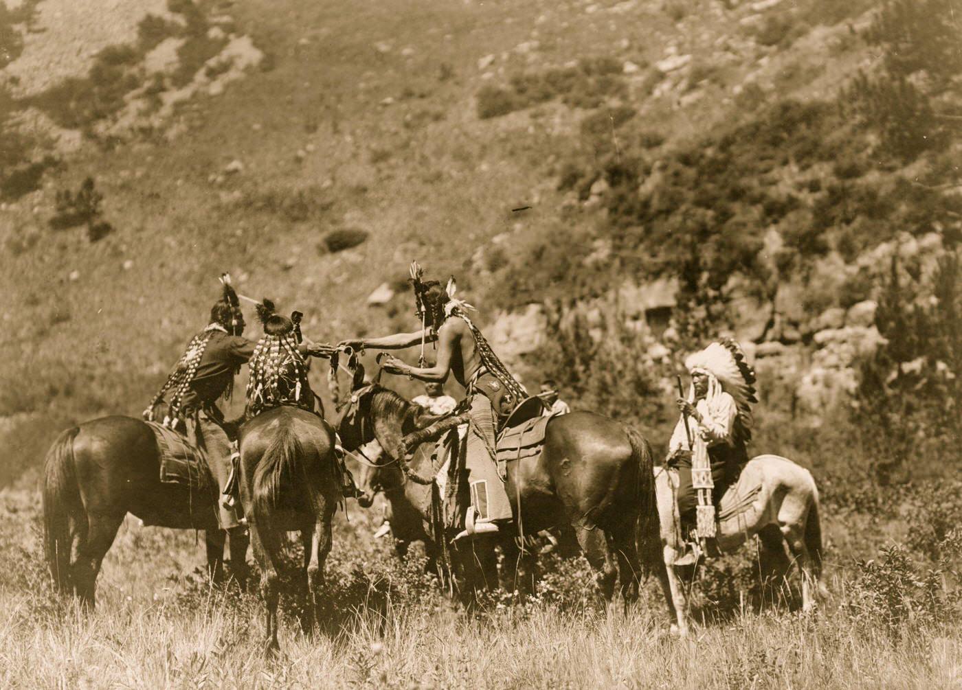 #9 Crow men on horseback apparently involved in an exchange, 1905