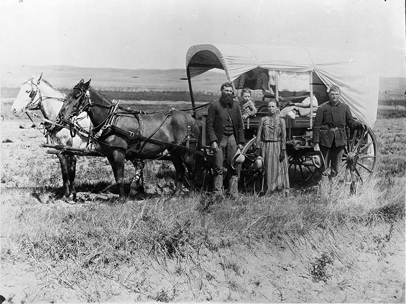 #90 A family with their covered wagon during the Great Western Migration in Loup Valley, Nebraska in 1886.