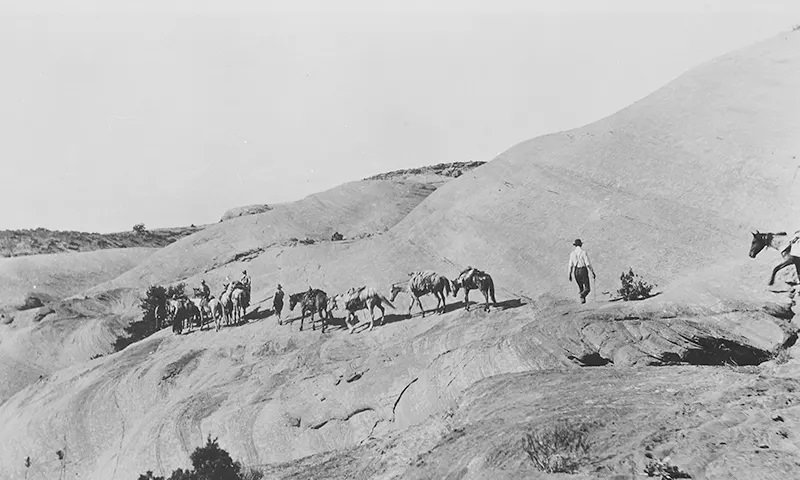 #91 Discovery party and horses on hot, slick rocks of Navajo Mountain on their way to Rainbow Bridge in Utah in 1909.