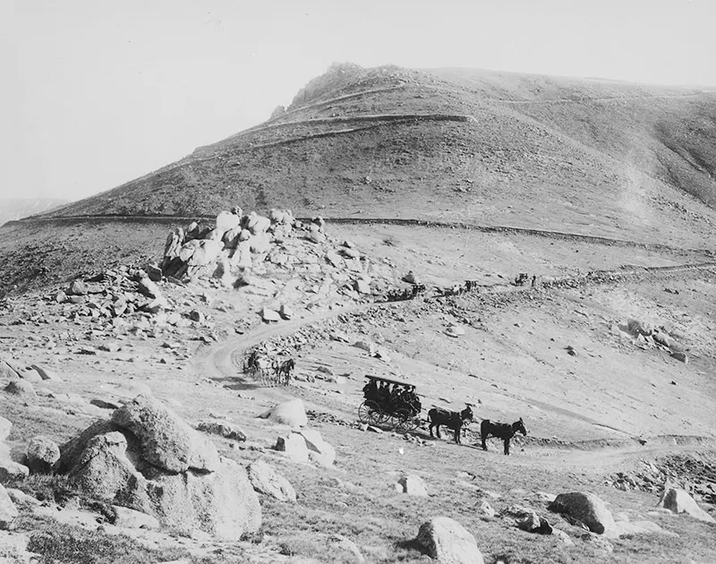 #97 Buckboard and coaches zigzagging down the “W” Pike’s Peak carriage road in Colorado in 1911.