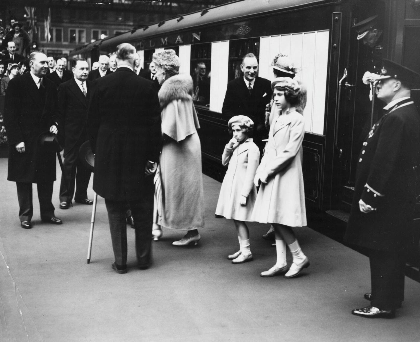 #13 Princesses Elizabeth and Margaret see off their parents, King George VI and Queen consort Elizabeth, at Waterloo Station, London, May 6th, 1939.