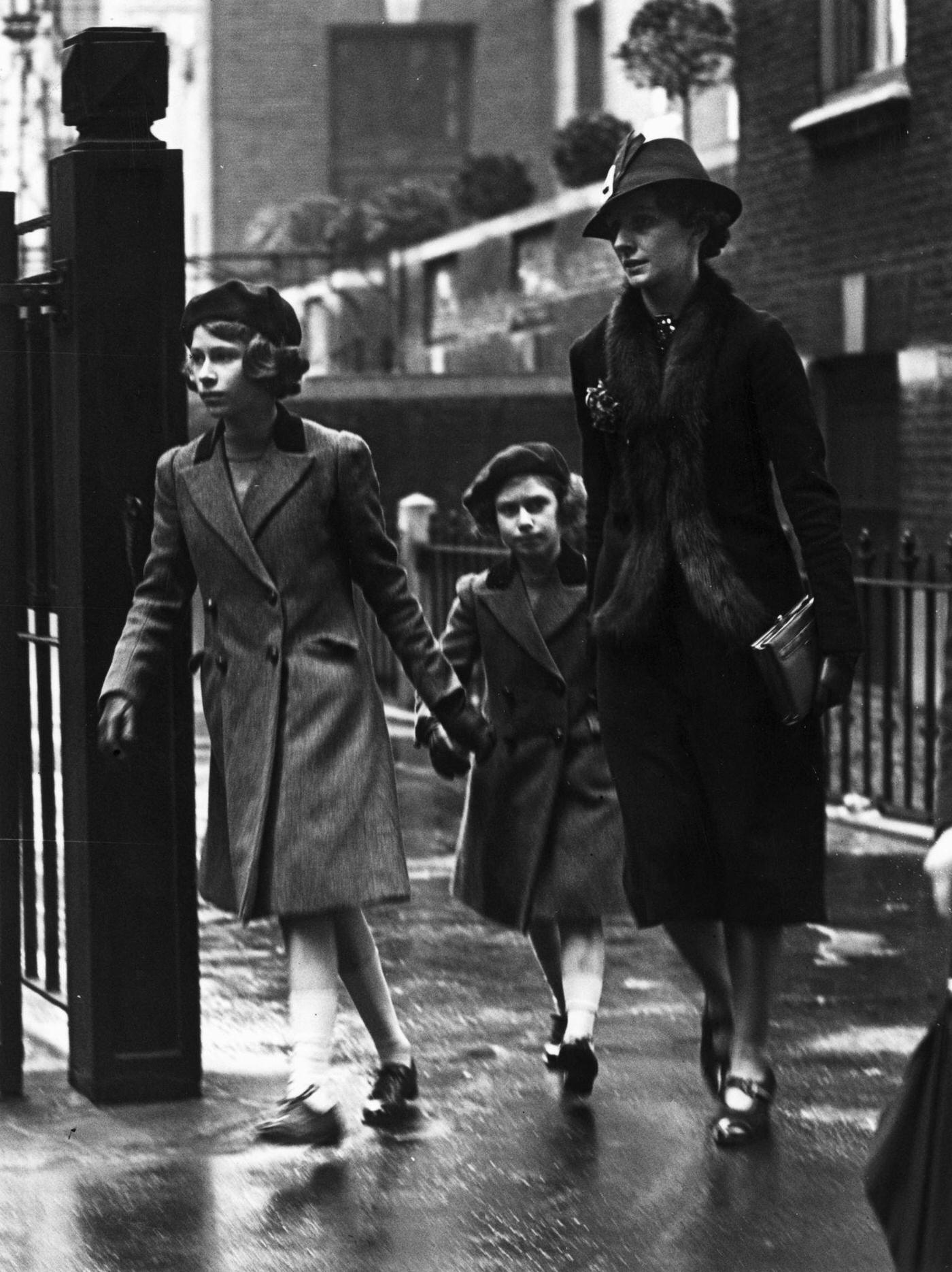 #14 Royalty and Nanny: Princess Elizabeth and her sister Princess Margaret with their nanny Miss Marion Crawford leaving the headquarters of the YWCA (Young Women’s Christian Association) in London, 15th May 1939.