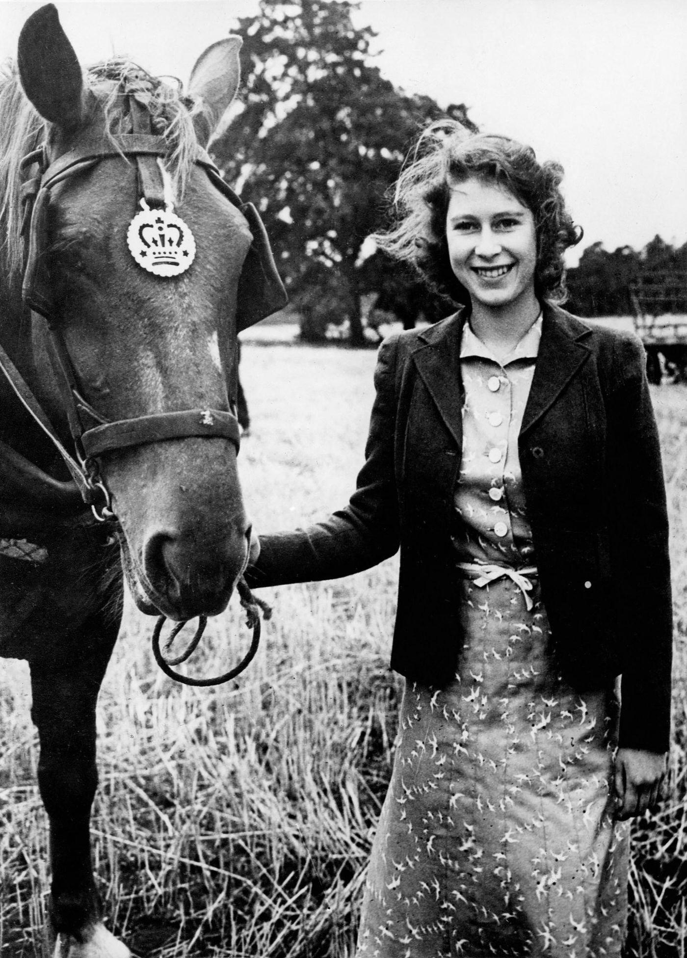 #27 Princess Elizabeth (the future Queen Elizabeth II) at Sandringham with one of the horses, undated.