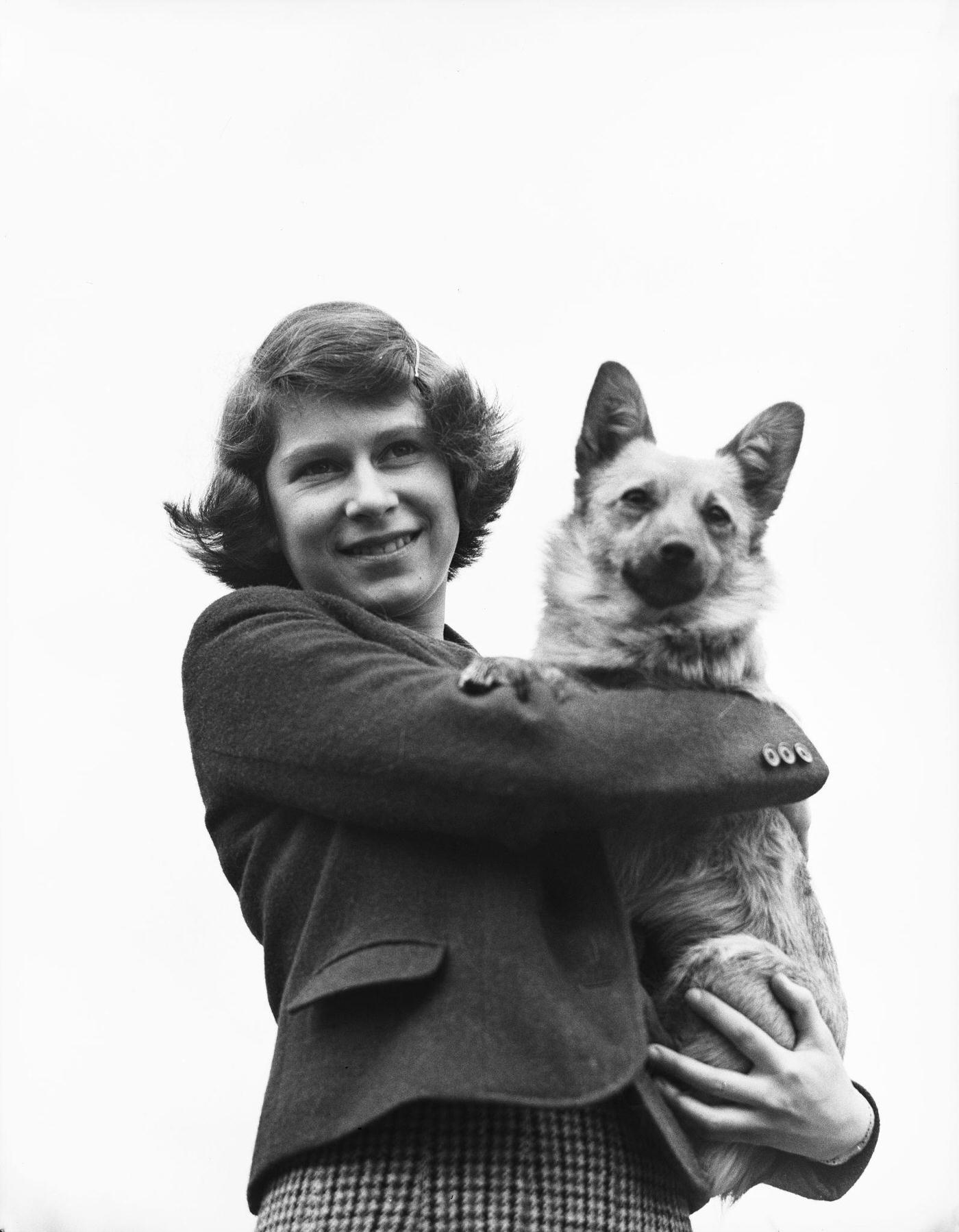 #31 The Royal Princess Elizabeth holding a Pembroke Welsh Corgi dog, UK, April 1940.