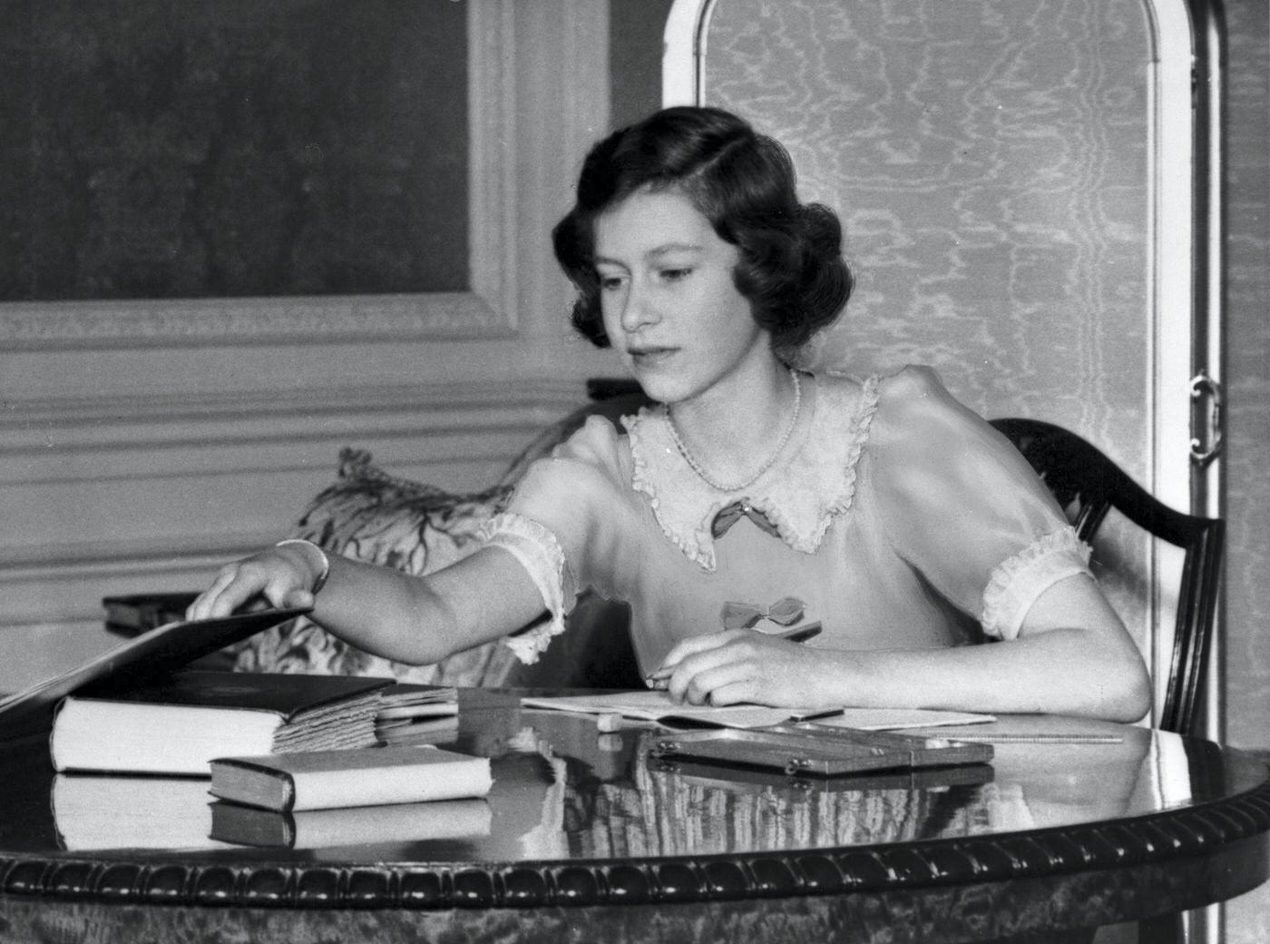 #43 Princess Elizabeth with a book at Windsor Castle, Berkshire, Great Britain, 22nd June 1940.