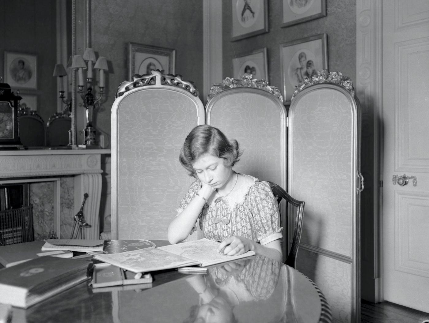 #44 Princess Elizabeth at a desk with books at Windsor Castle, Berkshire, Great Britain, 22nd June 1940.