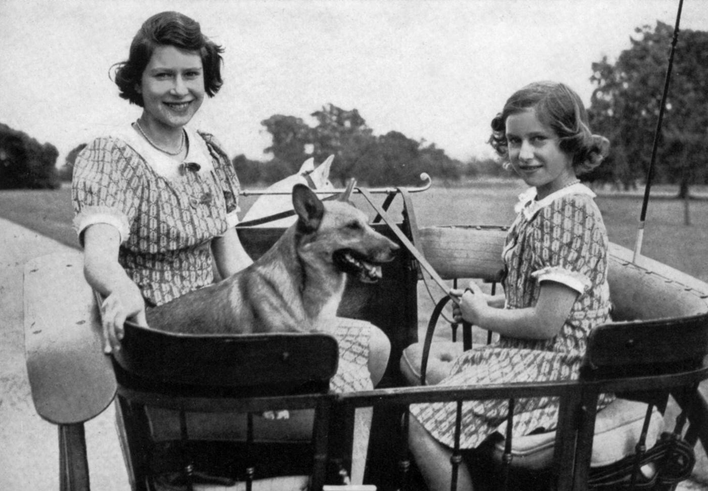 #50 Princess Elizabeth of England (future queen Elizabeth II) and her sister princess Margaret in gradens of Windsor, 1941