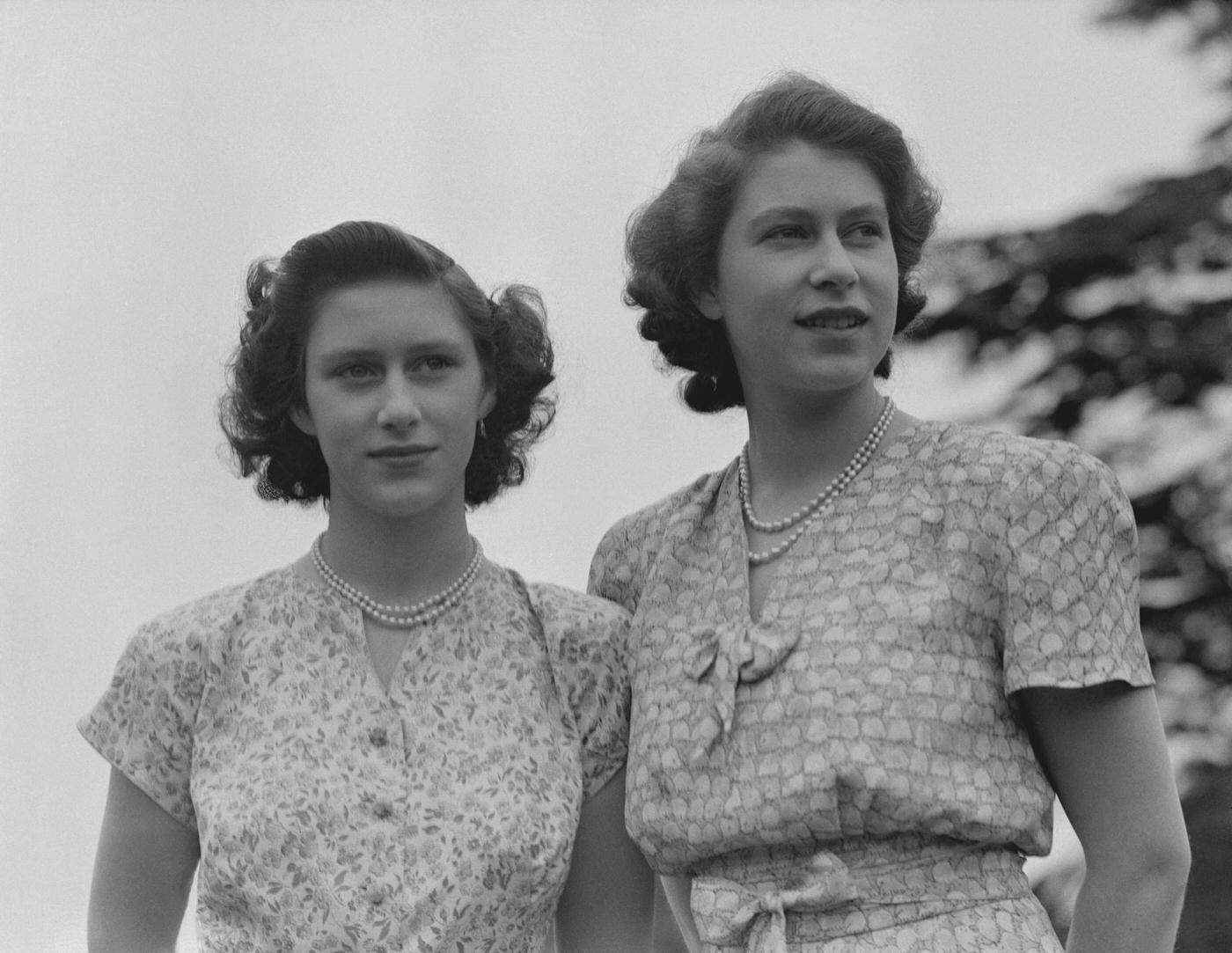 #55 Queen Elizabeth II and Princess Margaret wearing summer dresses, 1942.