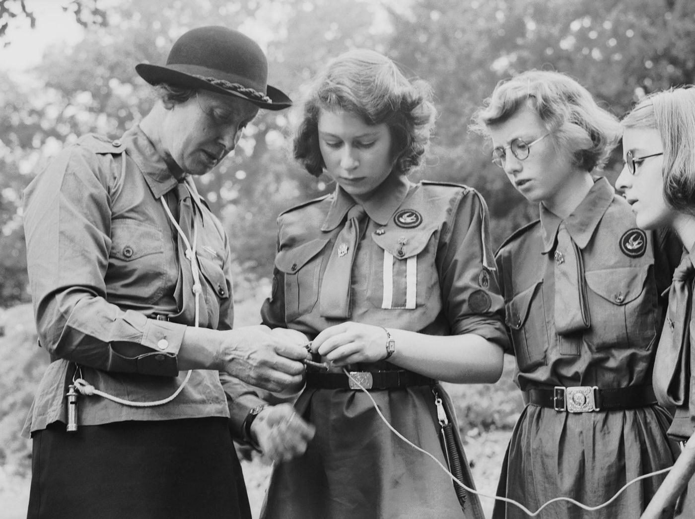 #62 Princess Elizabeth learns to tie a knot with the girl guides in Frogmore, Windsor, England on April 11, 1942.
