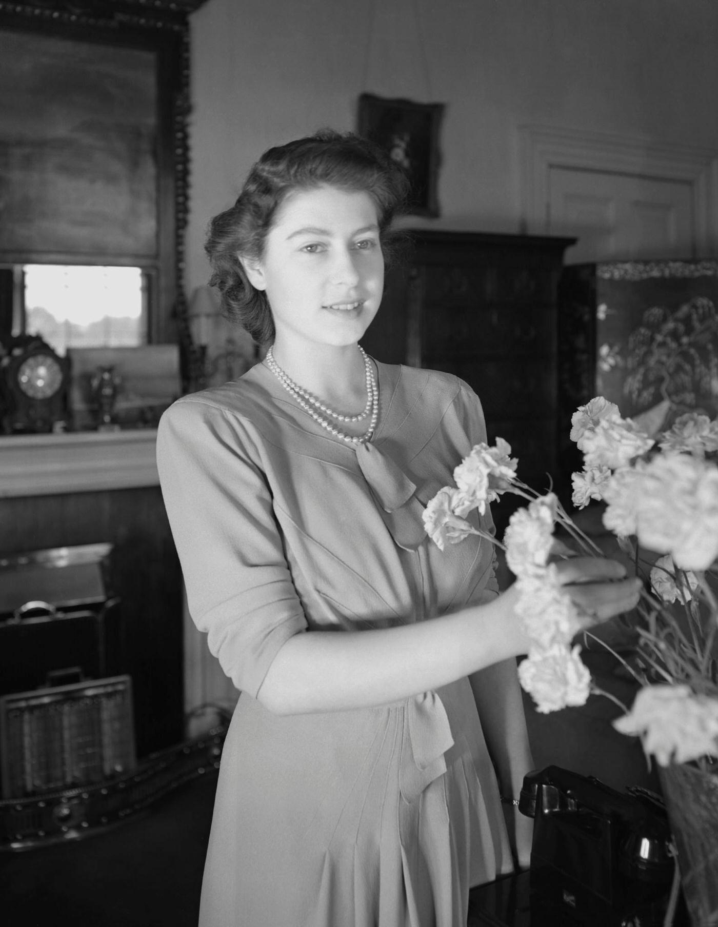#83 Princess Elizabeth (Queen Elizabeth II) arranging flowers at Windsor Castle, Great Britain, 8 July 1946.