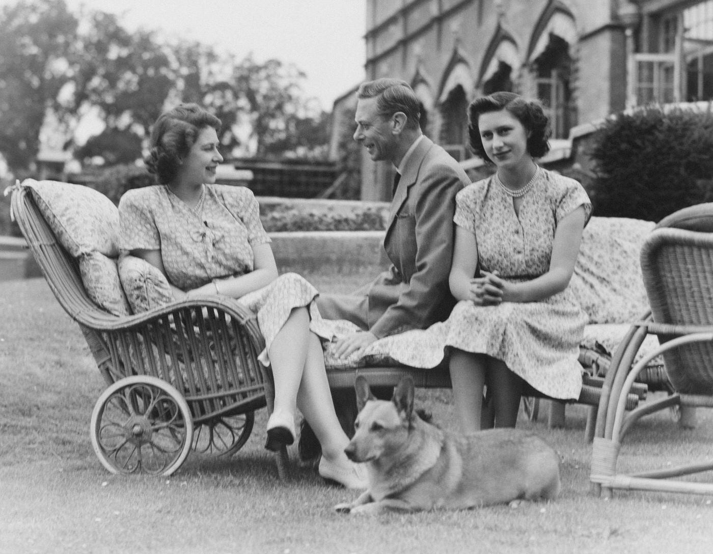 #86 King George VI with Princess Elizabeth and Princess Margaret at the Royal Lodge, Windsor, England, 8 July 1946.