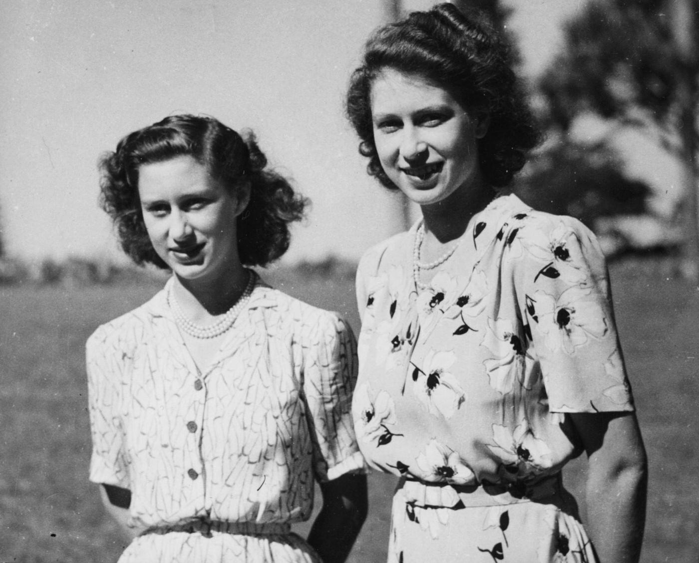 #95 Princess Elizabeth and Princess Margaret pictured standing together in the grounds of Government House in Bloemfontein during the Royal tour of South Africa, March 1947.
