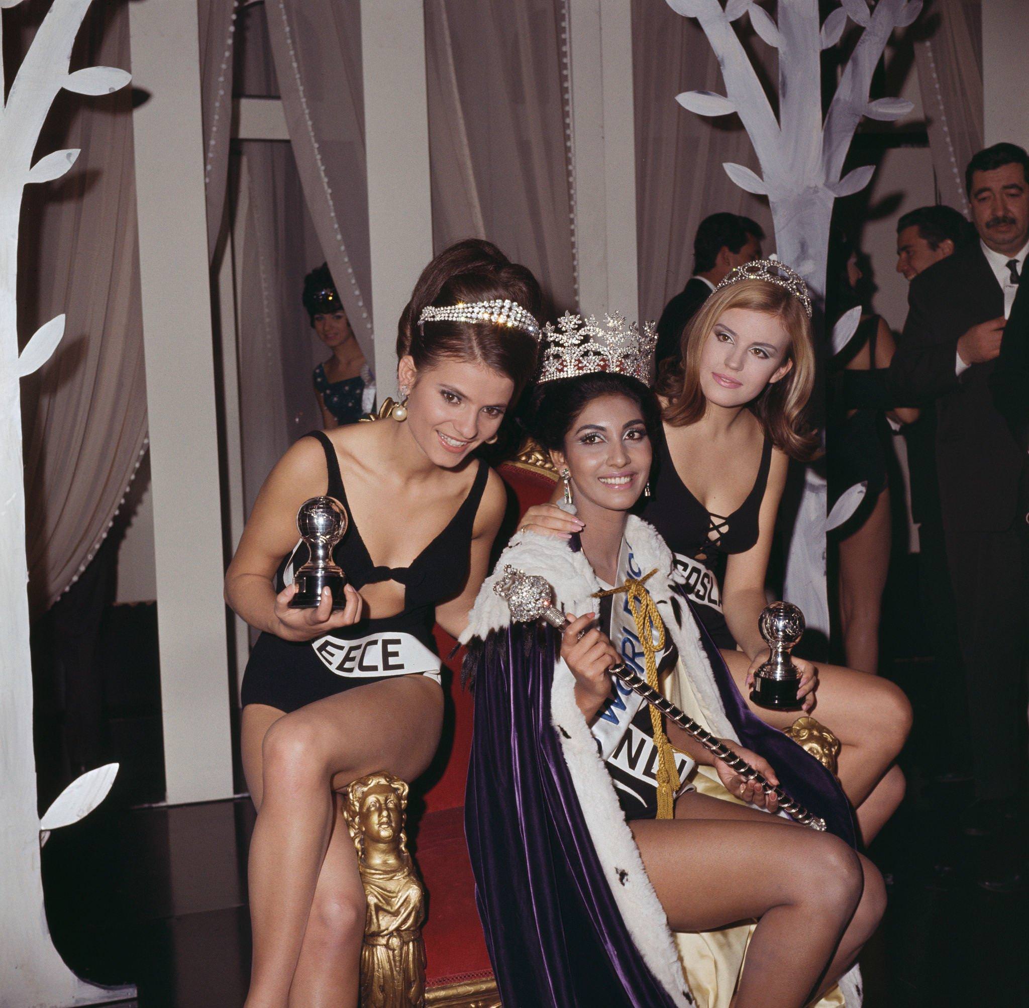 #36 Winner of Miss World 1966, Reita Faria of India wears her crown and sits on the winner’s throne with runners-up.