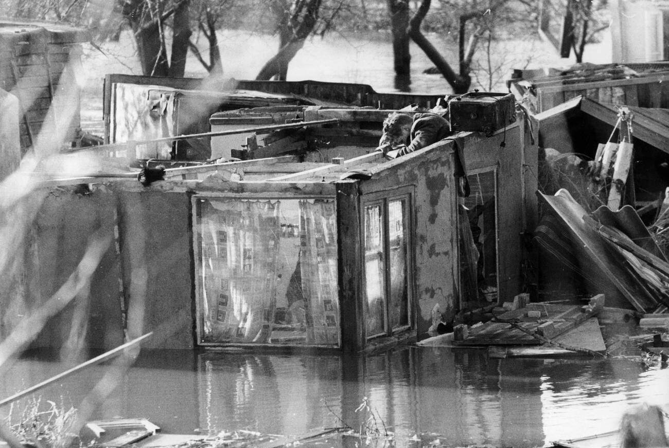 #57 Boy searching his parents’ house for useful items after the North Sea flood of 1962 in Hamburg, West Germany