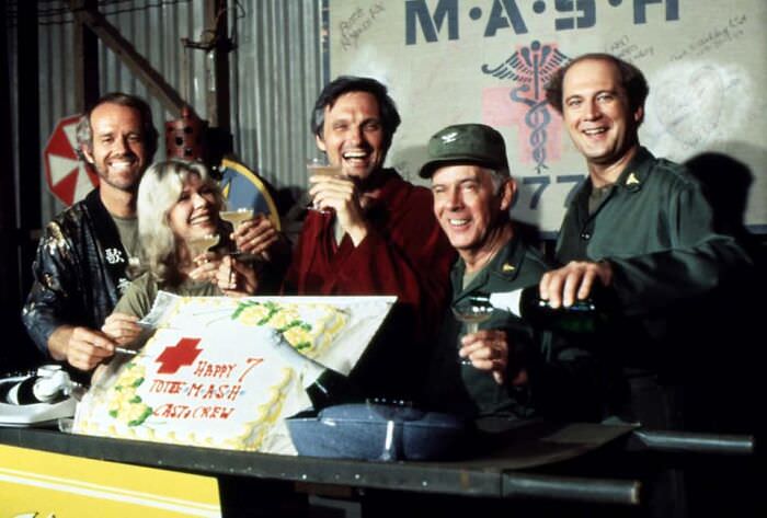 #10 Mike Farrell, Loretta Swit, Alan Alda, Harry Morgan, and David Ogden Stiers raise a toast and a cake at a 7th anniversary cast party