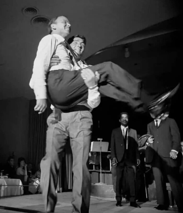 #27 Frank Sinatra gets carried off stage by Dean Martin while Sammy Davis Jr. watches, photo by Art Shay, Las Vegas, 1961