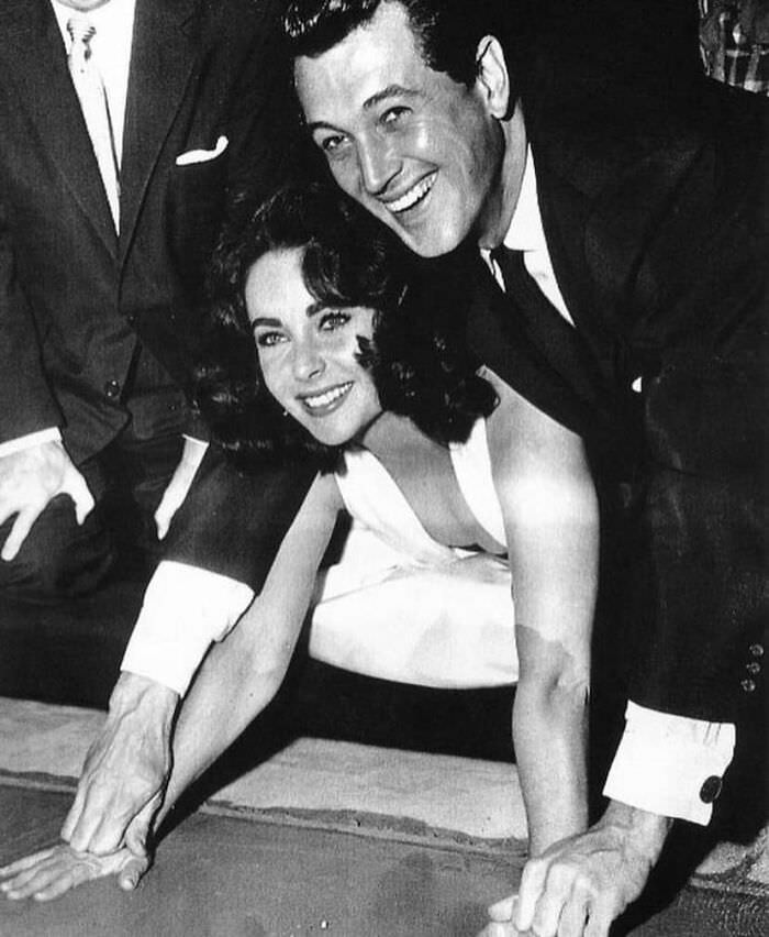 #60 Liz Taylor and Rock Hudson cementing their handprints at the Grauman’s Chinese Theatre