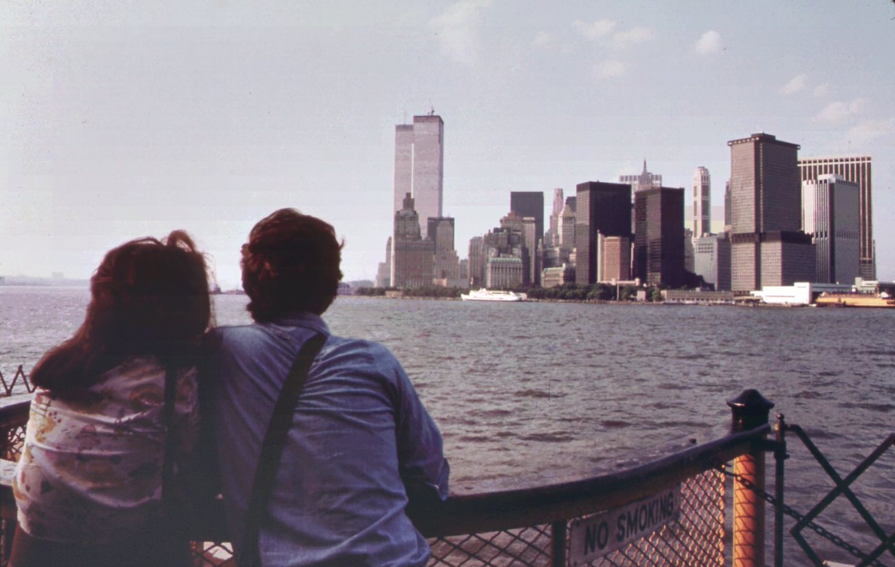 #106 On the staten island ferry, looking back toward the skyline of lower manhattan. To the left of the cluster of buldings are the towers of the world trade center, 1970s