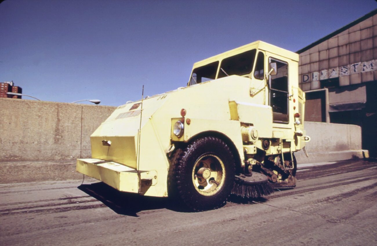 #109 Garbage truck at the 91st street marine transfer station (mts). From the mts, garbage is carried by barge down the east river to the landfill dump on staten island, 1970s