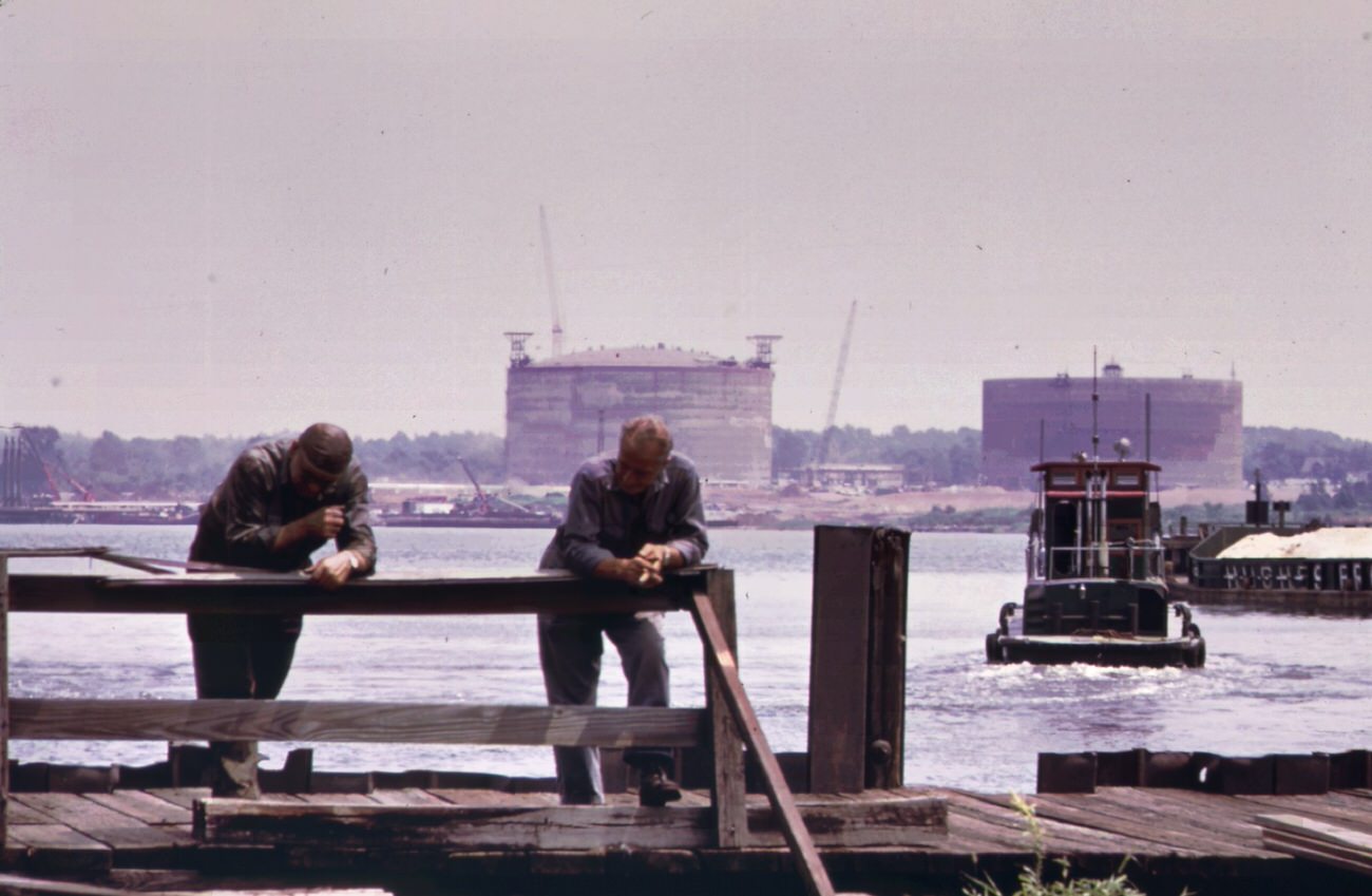 #81 The texas eastern gas tank (in background) on staten island as seen from the opposite side of arthur kill at port reading, 1970s