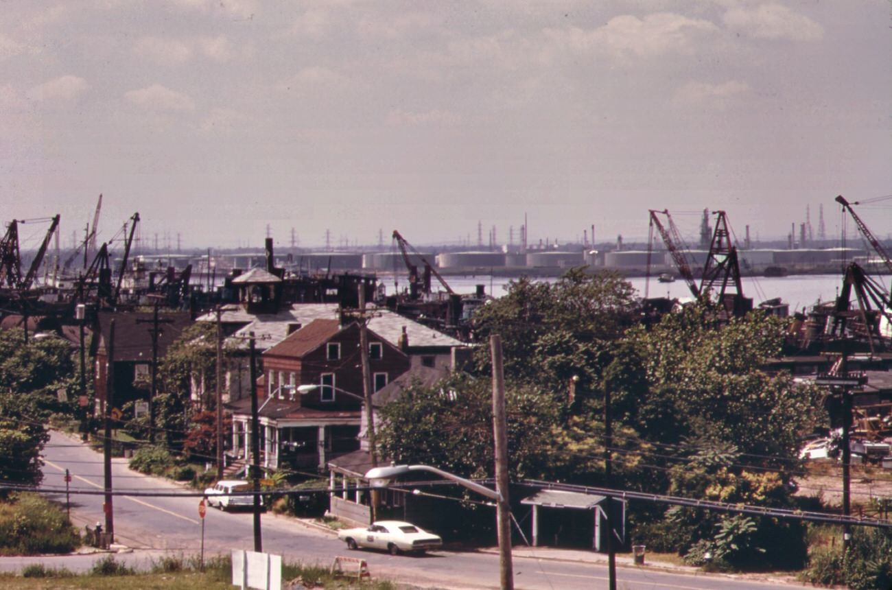 #96 Arthur kill road in staten island, looking south. Private houses are almost engulfed by encroaching industries. In background is the arthur kill and the new jersey shore, 1970s