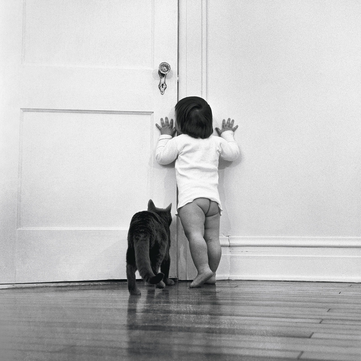 #6 Chandoha’s daughter Paula is trailed by the family cat, Loco, in 1951.