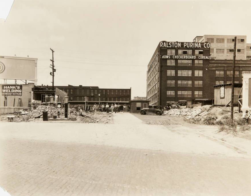 #9 Workers clearing debris from a partially collapsed building near 835 S. 8th Street. Buildings for the Ralston Purina Co., 8th Street Scale, and Hank’s Welding can be seen, 1930