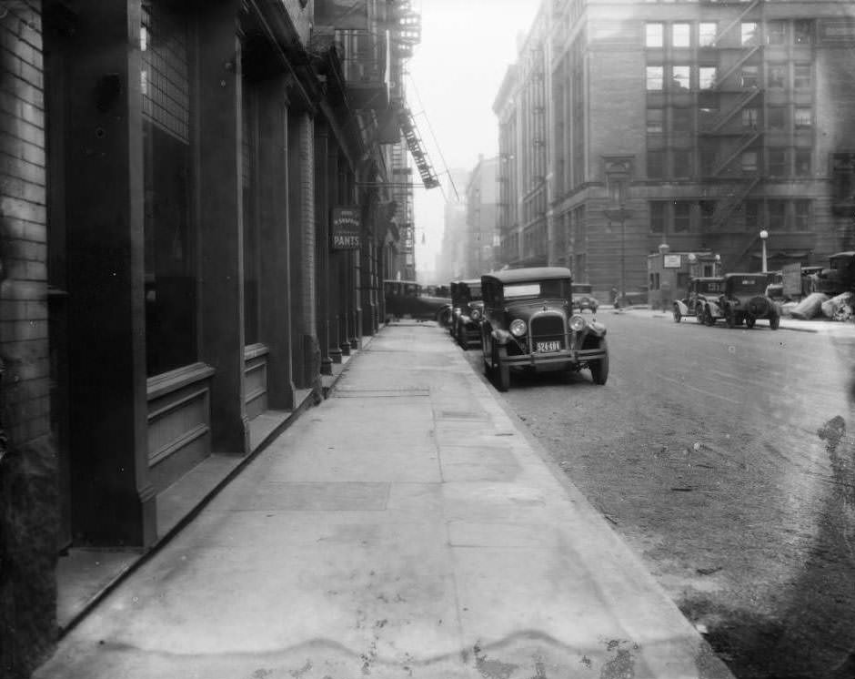 #135 View east down Lucas Ave. towards 9th St. with H. Siegfried Fine Pants store and Lammert Furniture Building visible, 1930