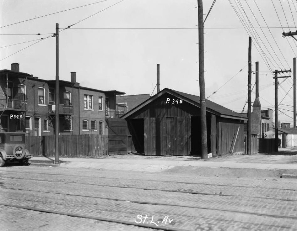 #154 View of a garage and rears of multi-family residences, 1930