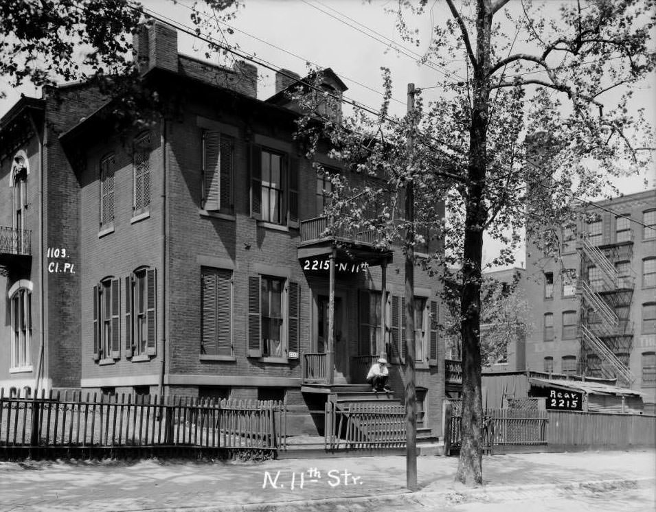 #156 View of a large home on North 11th Street between Clinton Place and Monroe with a man sitting on the porch, 1930