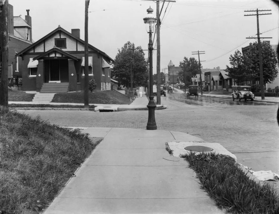 #159 View looking east down Osceola at South Compton in the Dutchtown neighborhood with a woman and child walking away from the camera, 1930