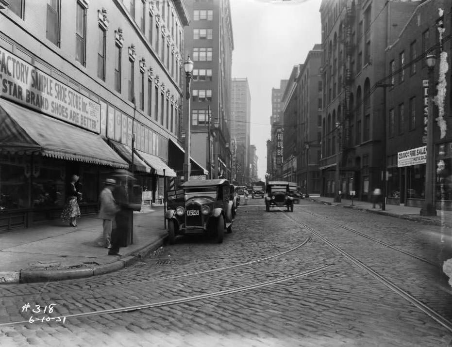 #70 Looking south down North Seventh Street from intersection with Morgan Street, view of The Hub furniture store, Richman Brothers, and Busy Bee Candy Co, 1931