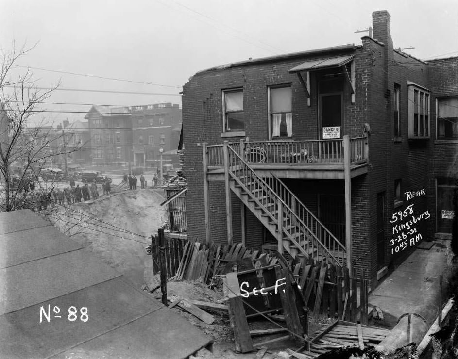 #78 Kingsbury Pharmacy at 5958 Kingsbury in University City after collapse, with a row of onlookers watching from below, 1931