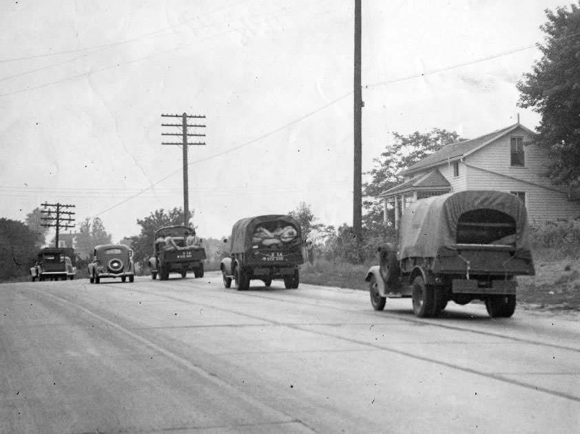 #116 Army trucks prepare and march, 1930.