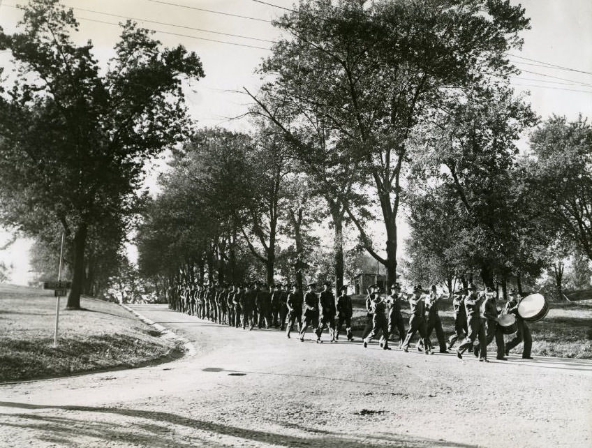 #117 Army men led by bass drummers of marching band, 1930.