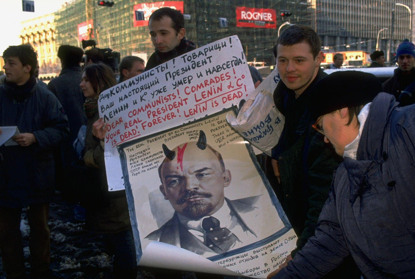 #12 Counter-demonstrators with Russian-English sign portraying Lenin as a horned devil during pro-communist demonstration.