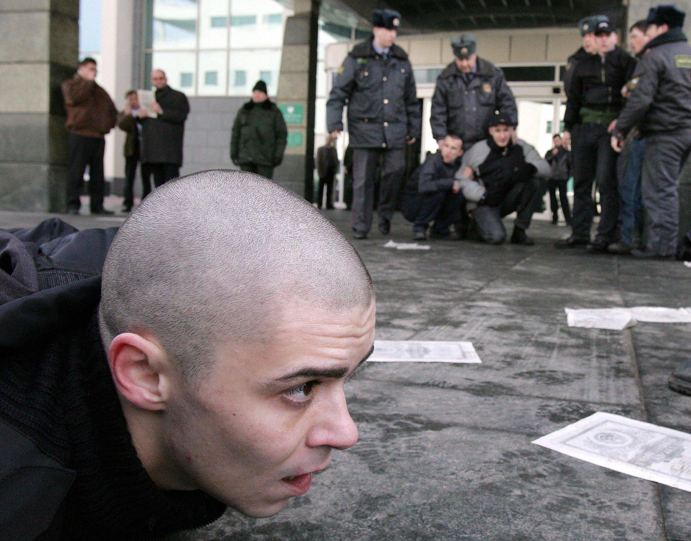 #14 National-Bolshevik Party member lies on ground after being arrested by Russian police during protest outside “Sberbank” in Moscow demanding compensation for savings lost during Soviet collapse in 1991.