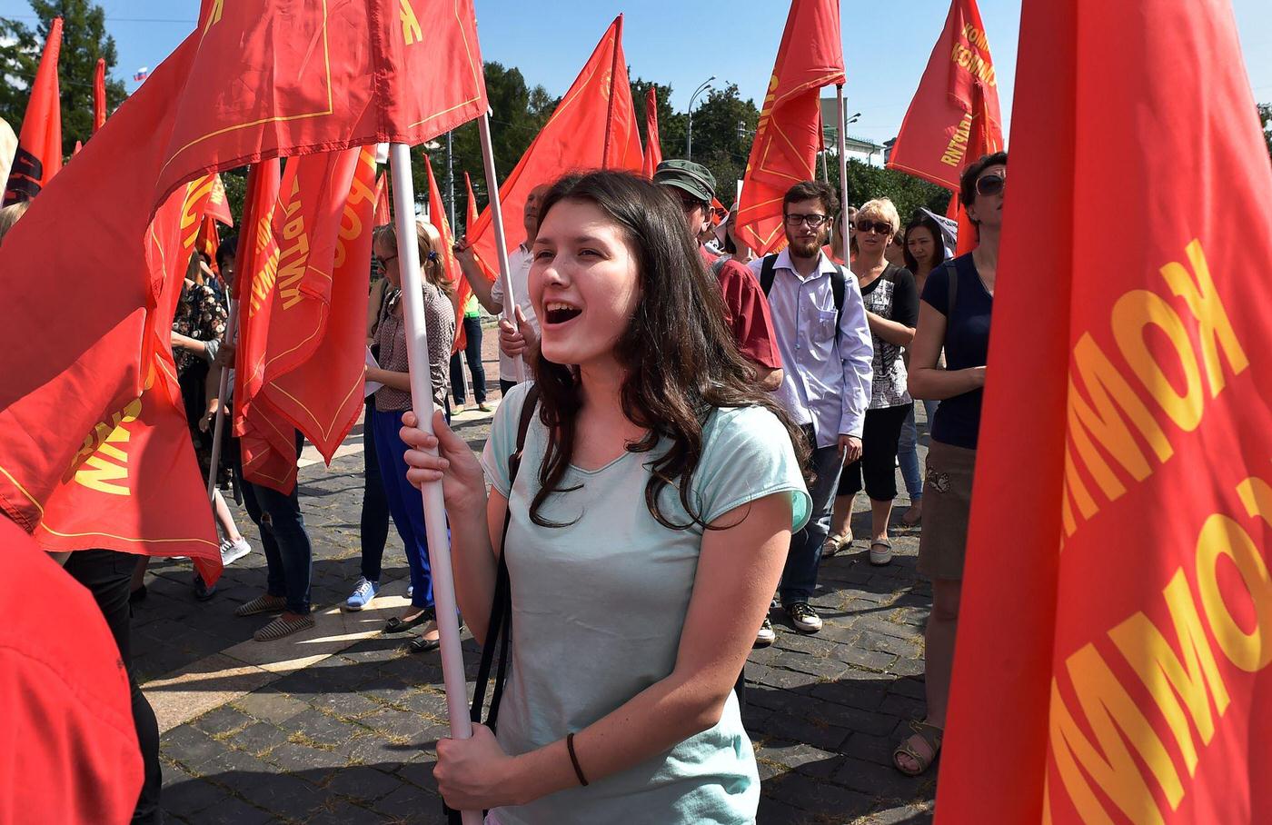 #8 Russian Communist supporter holds red flag and shouts slogans during rally in downtown Moscow marking the 25th anniversary of the August 1991 putsch.