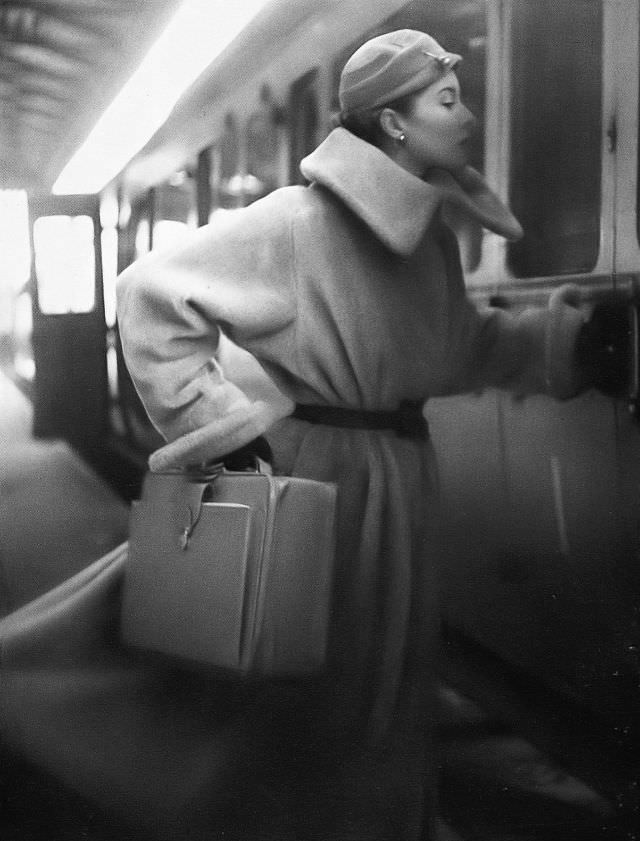 #31 Barbara Goalen in long-haired fleecy coat in alpaca and wool at Marcel, velvet cloche at R.M. Hats, pigskin case at Elizabeth Arden, 1952.