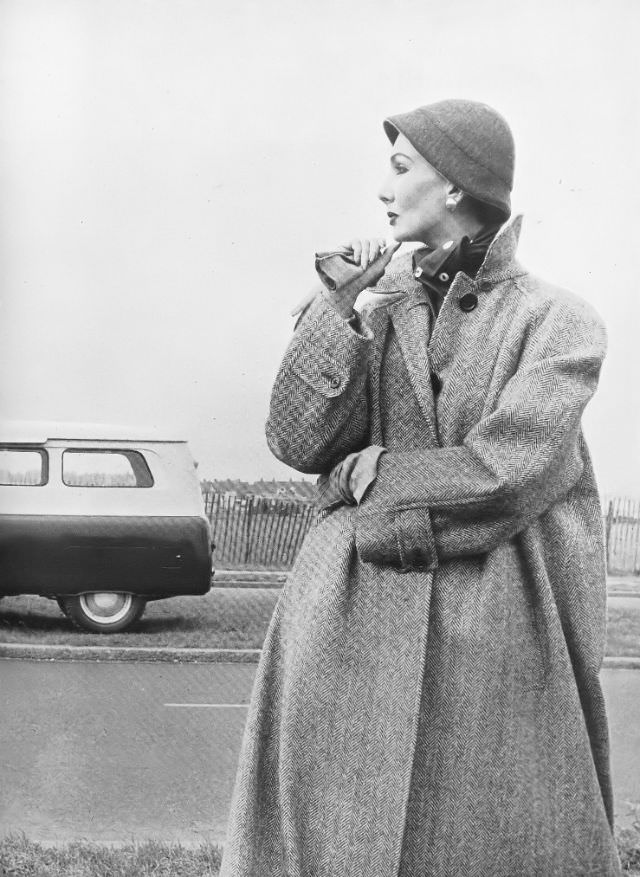 #33 Barbara Goalen in stone-and-white herringbone, single-breasted coat by Aquascutum, 1952.
