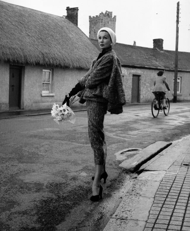 #40 Barbara Goalen in a shaggy woollen suit with sleeveless sling cape by Sybil Connolly, photo by Milton Greene, 1953.